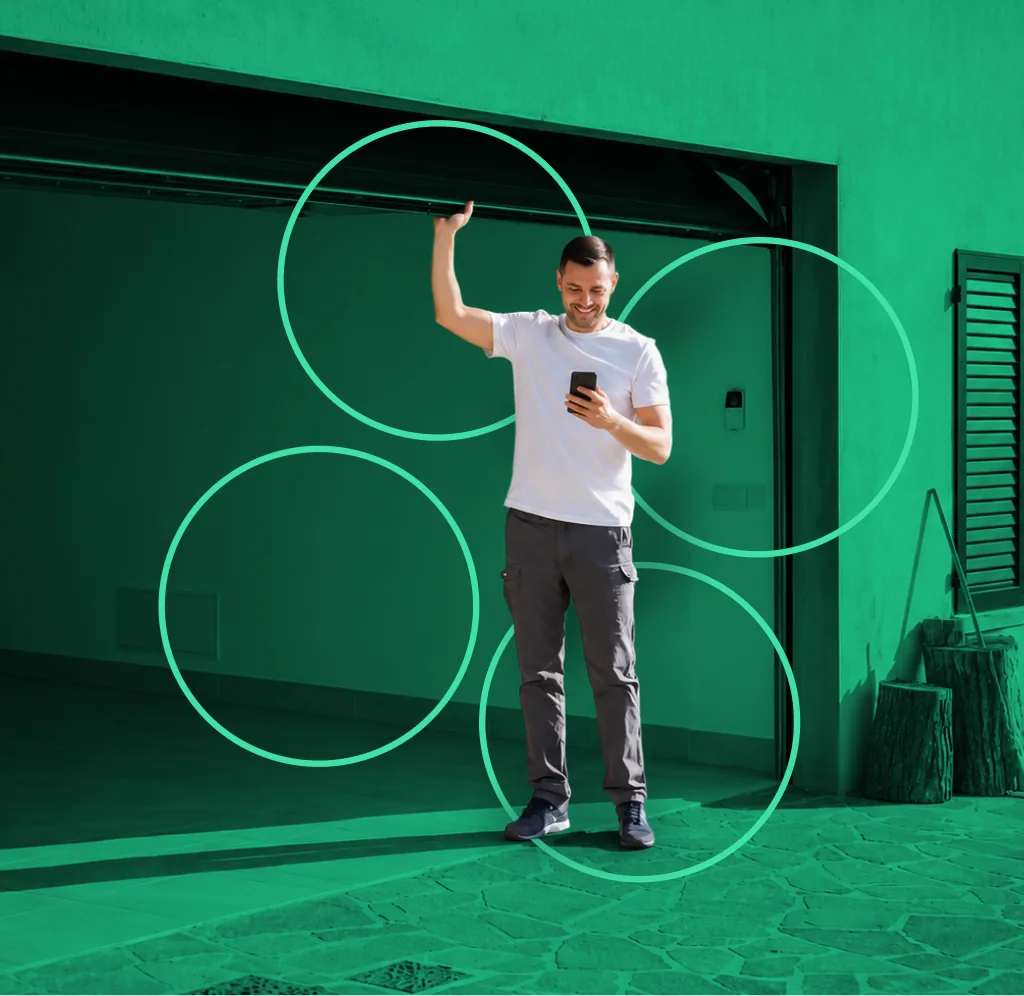 A host in his garage, happily checking his phone