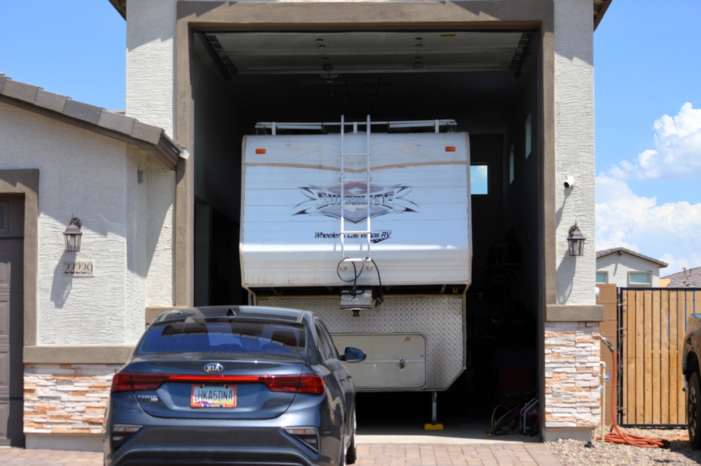 An RV parked in a residential car garage