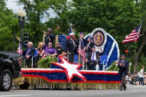 Colorful Memorial Day parade float passing along Constitution Avenue